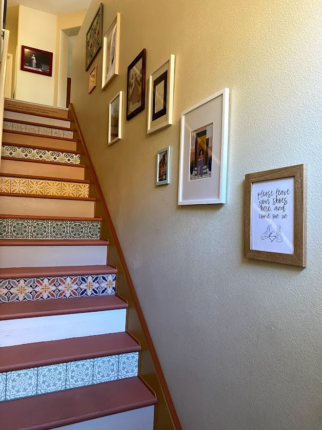 Photo of an eclectic painted wood straight staircase in Las Vegas with painted wood risers and wood railing.