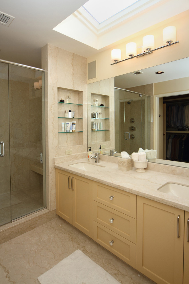 Photo of a large traditional master bathroom in Calgary with an undermount sink, shaker cabinets, yellow cabinets, granite benchtops, an alcove shower, a one-piece toilet, beige tile, porcelain tile, beige walls and porcelain floors.