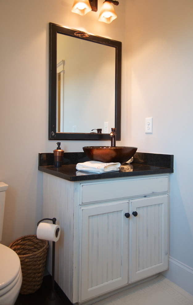 Mid-sized arts and crafts kids bathroom in Charlotte with a vessel sink, raised-panel cabinets, distressed cabinets, granite benchtops, an open shower, a one-piece toilet, brown tile, ceramic tile, beige walls and ceramic floors.