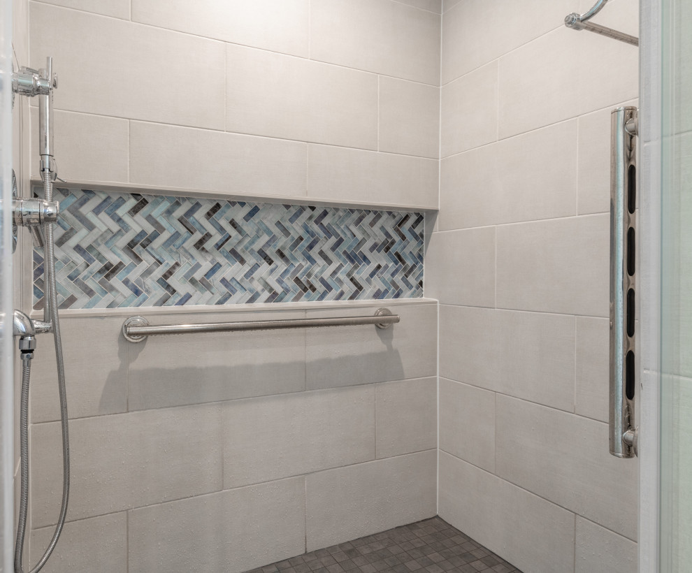 Photo of a mid-sized traditional master bathroom in Other with recessed-panel cabinets, brown cabinets, a corner shower, multi-coloured tile, matchstick tile, grey walls, an undermount sink, beige floor, a hinged shower door and white benchtops.