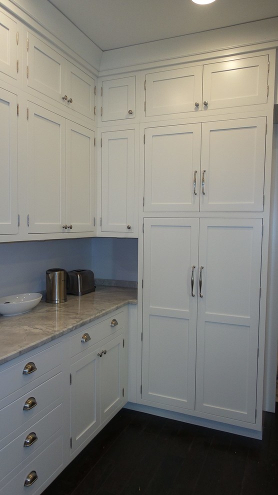 Mid-sized transitional l-shaped dark wood floor and brown floor enclosed kitchen photo in Chicago with a single-bowl sink, beaded inset cabinets, white cabinets, granite countertops, stainless steel appliances and no island