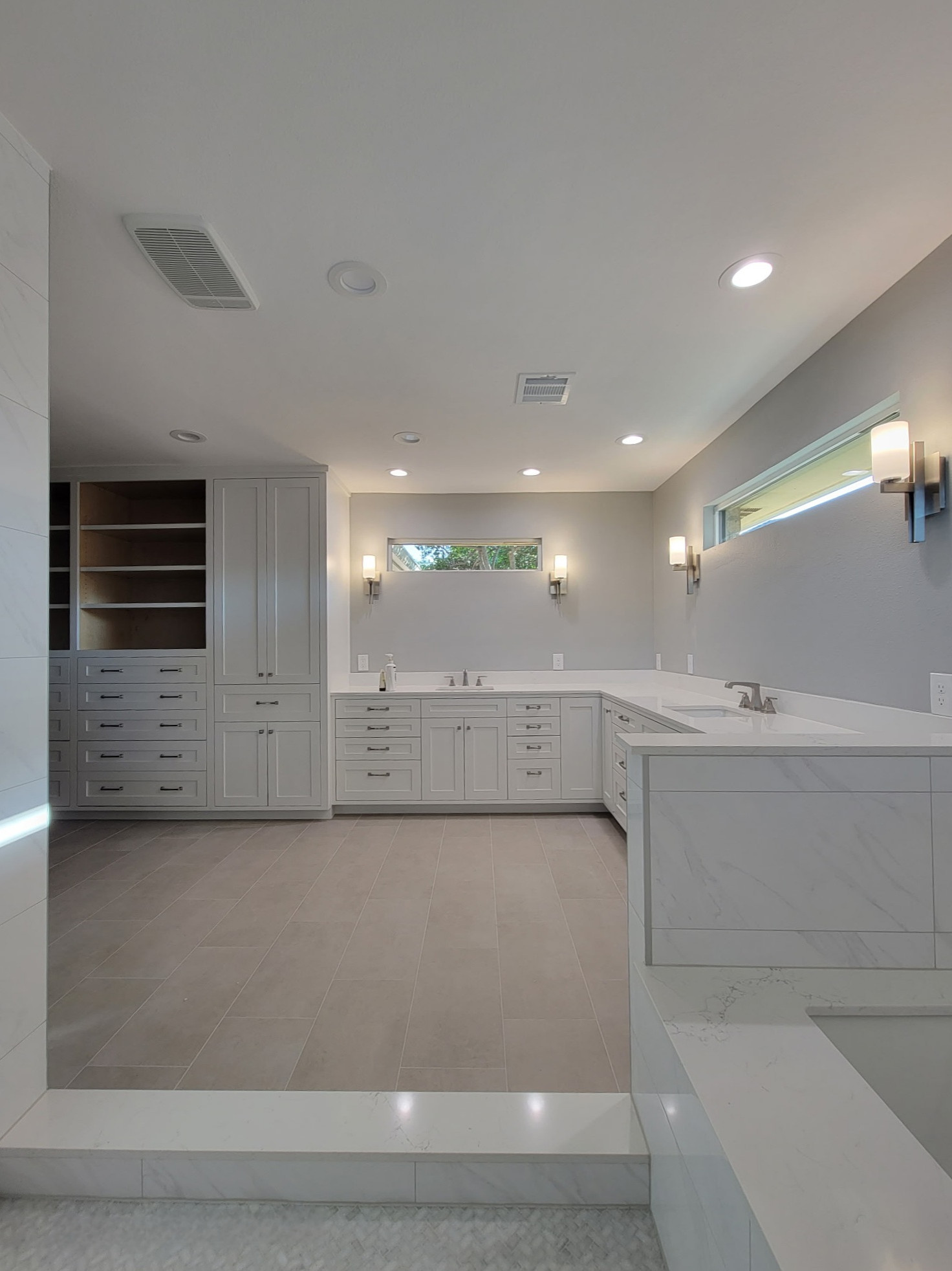 Two separate bathrooms converted into a master bathroom with a big open closet