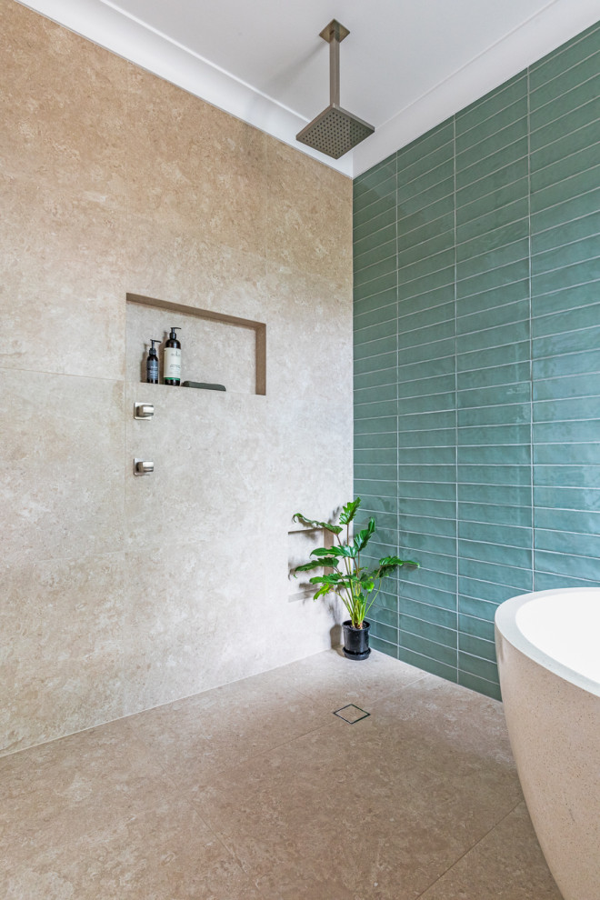 Inspiration for a medium sized world-inspired ensuite bathroom in Other with freestanding cabinets, light wood cabinets, a freestanding bath, a walk-in shower, green tiles, ceramic tiles, beige walls, porcelain flooring, a vessel sink, wooden worktops, beige floors, an open shower, a wall niche, a single sink and a freestanding vanity unit.