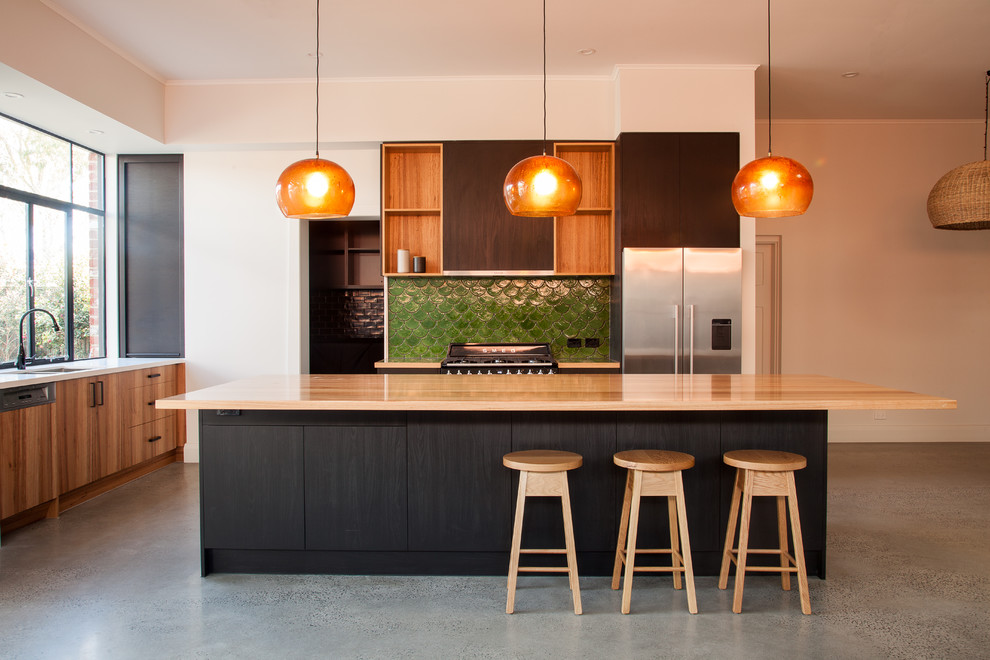 Inspiration for a contemporary l-shaped kitchen pantry in Adelaide with a double-bowl sink, flat-panel cabinets, black cabinets, wood benchtops, green splashback, terra-cotta splashback, stainless steel appliances, concrete floors, with island and grey floor.