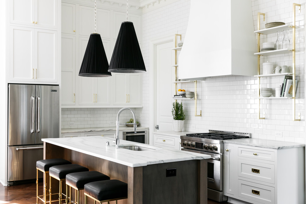 Inspiration for a large transitional l-shaped eat-in kitchen in Louisville with an undermount sink, beaded inset cabinets, marble benchtops, white splashback, subway tile splashback, stainless steel appliances, medium hardwood floors, with island and brown floor.