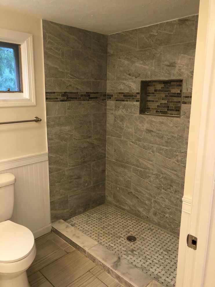 Mid-sized contemporary kids bathroom in Boston with raised-panel cabinets, grey cabinets, an alcove tub, a shower/bathtub combo, gray tile, travertine, marble benchtops, white benchtops, a single vanity and a freestanding vanity.