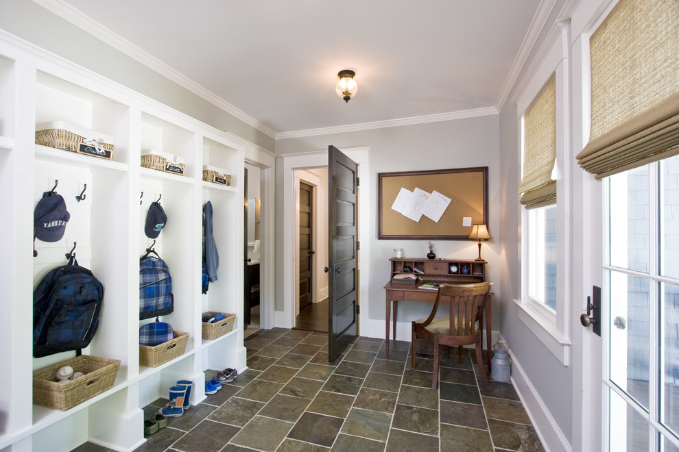 Photo of a traditional mudroom in New York with grey walls, slate floors, a single front door, a glass front door and multi-coloured floor.