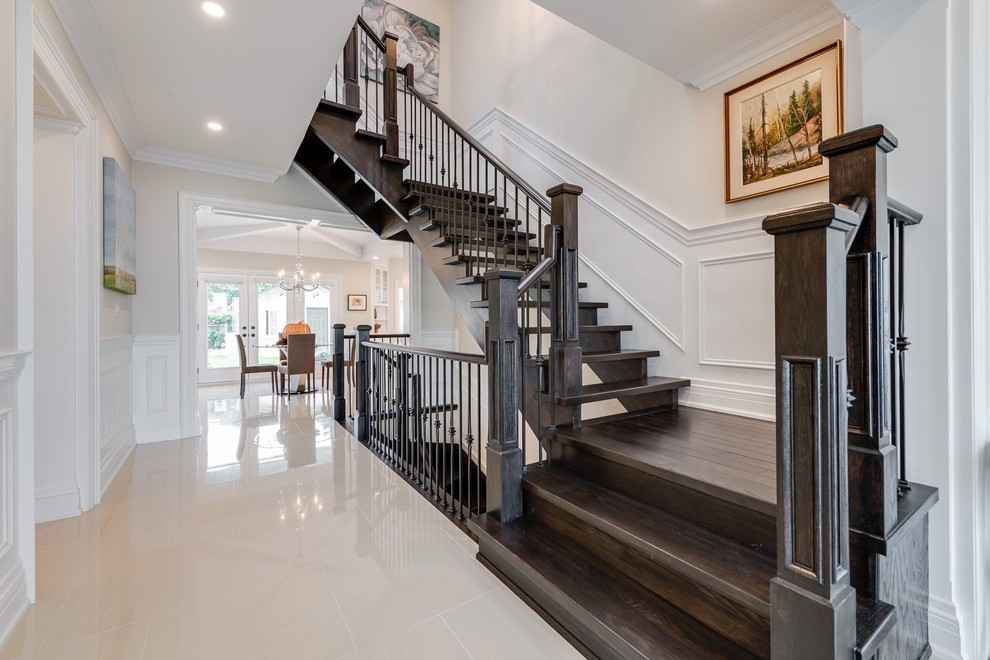 Inspiration for a large contemporary wood l-shaped staircase in Toronto with open risers and wood railing.