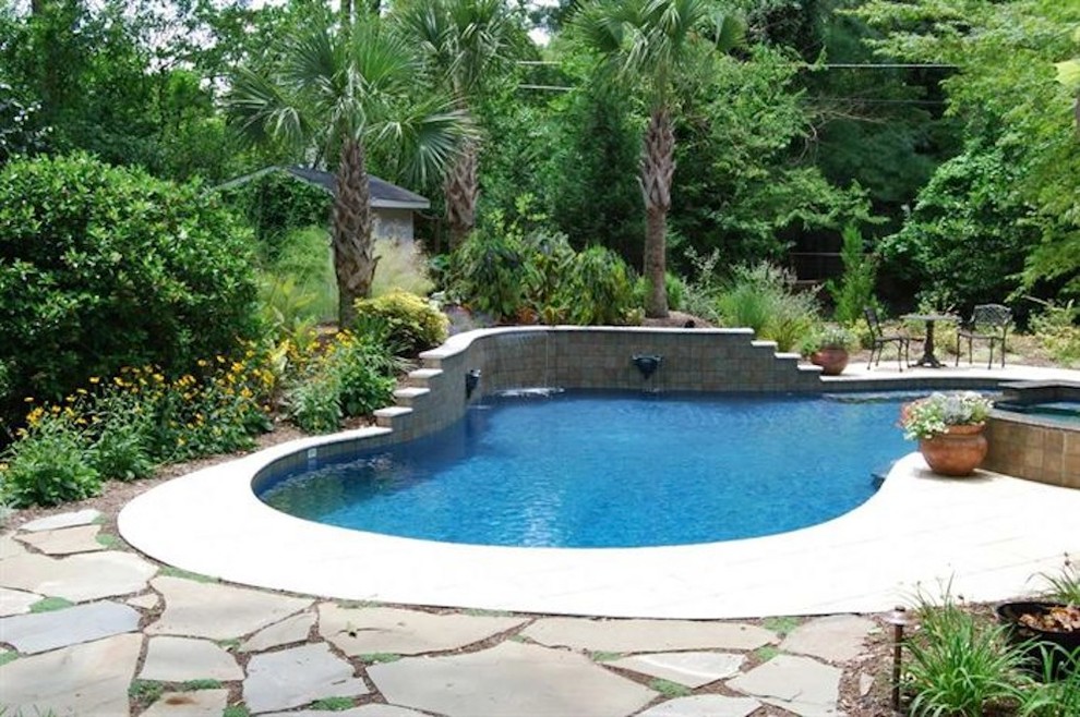 Pool fountain - mid-sized backyard stone and rectangular natural pool fountain idea