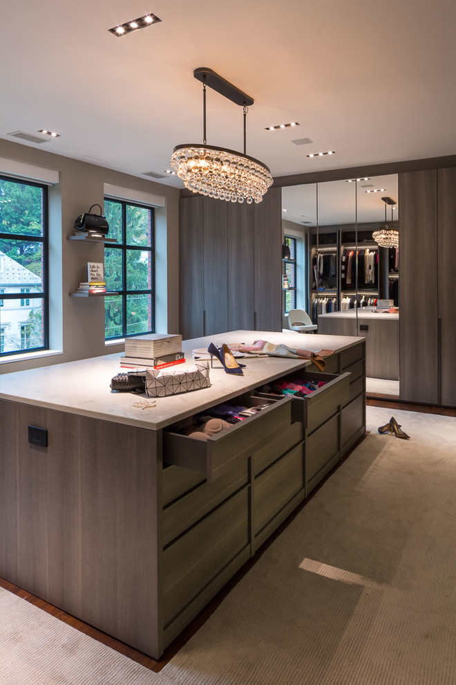 Expansive contemporary women's walk-in wardrobe in DC Metro with flat-panel cabinets, medium wood cabinets, carpet and beige floor.