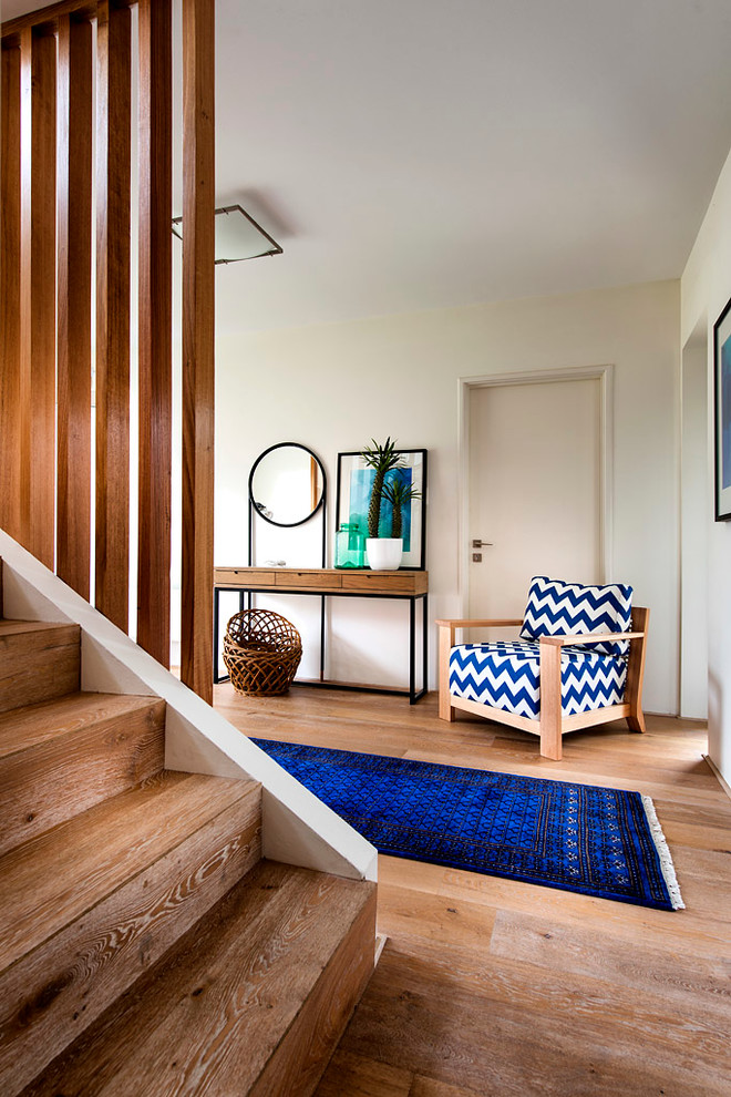 This is an example of a midcentury hallway in Perth with orange floor and light hardwood floors.