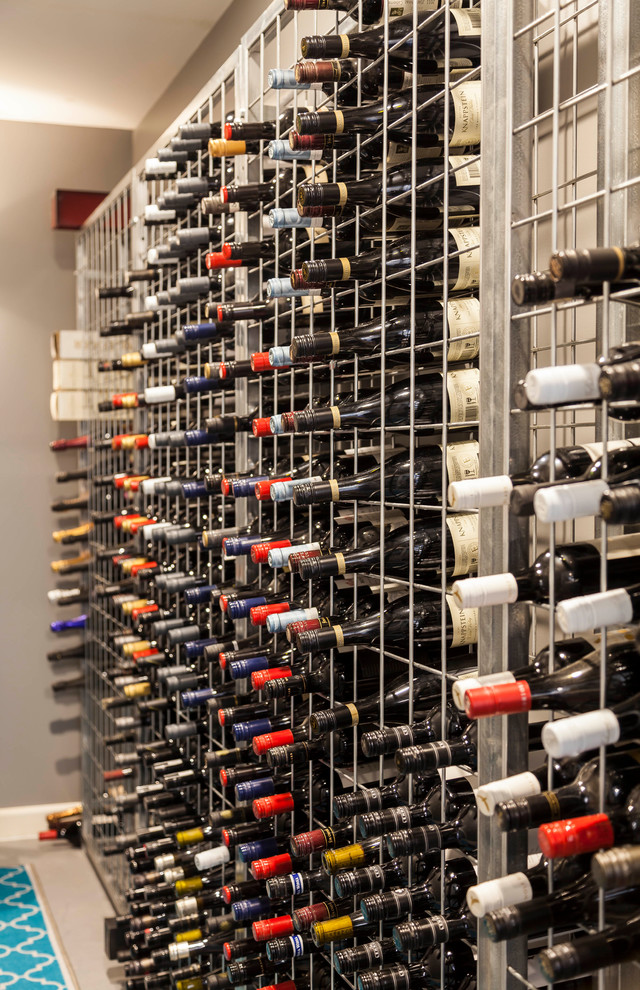 Mid-sized midcentury wine cellar in Melbourne with carpet, storage racks and beige floor.