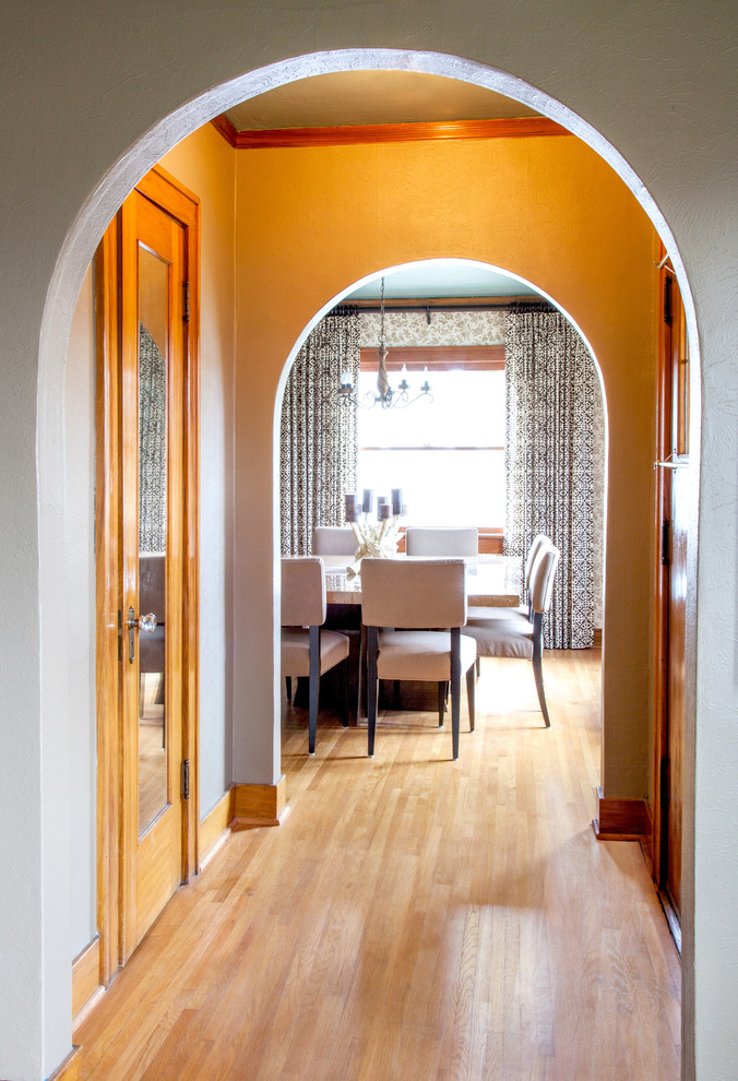 Photo of an eclectic dining room in Portland with medium hardwood floors.