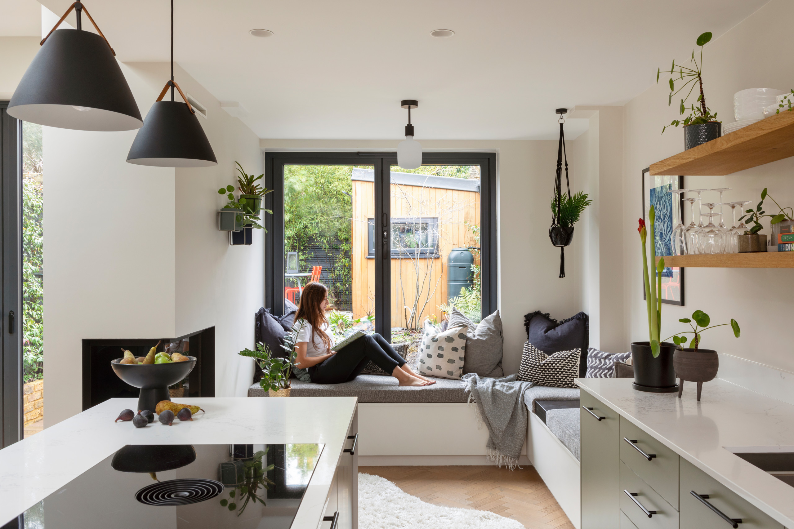 Kitchen - contemporary medium tone wood floor kitchen idea in London with flat-panel cabinets, green cabinets, quartzite countertops and white countertops