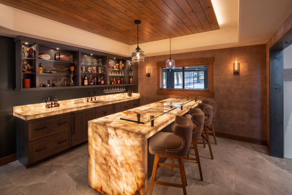 This is an example of a large rustic galley wet bar in Other with a submerged sink, shaker cabinets, grey cabinets, onyx worktops, grey splashback, metal splashback, porcelain flooring, grey floors and multicoloured worktops.