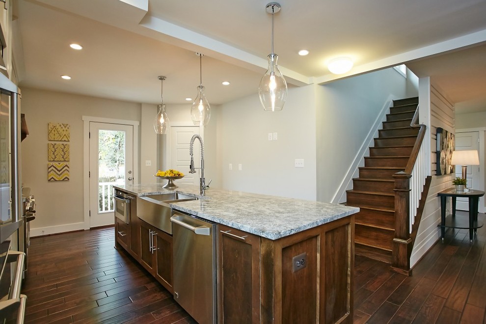 This is an example of a large contemporary l-shaped open plan kitchen in DC Metro with a double-bowl sink, shaker cabinets, white cabinets, granite benchtops, beige splashback, stone slab splashback, stainless steel appliances, dark hardwood floors and with island.