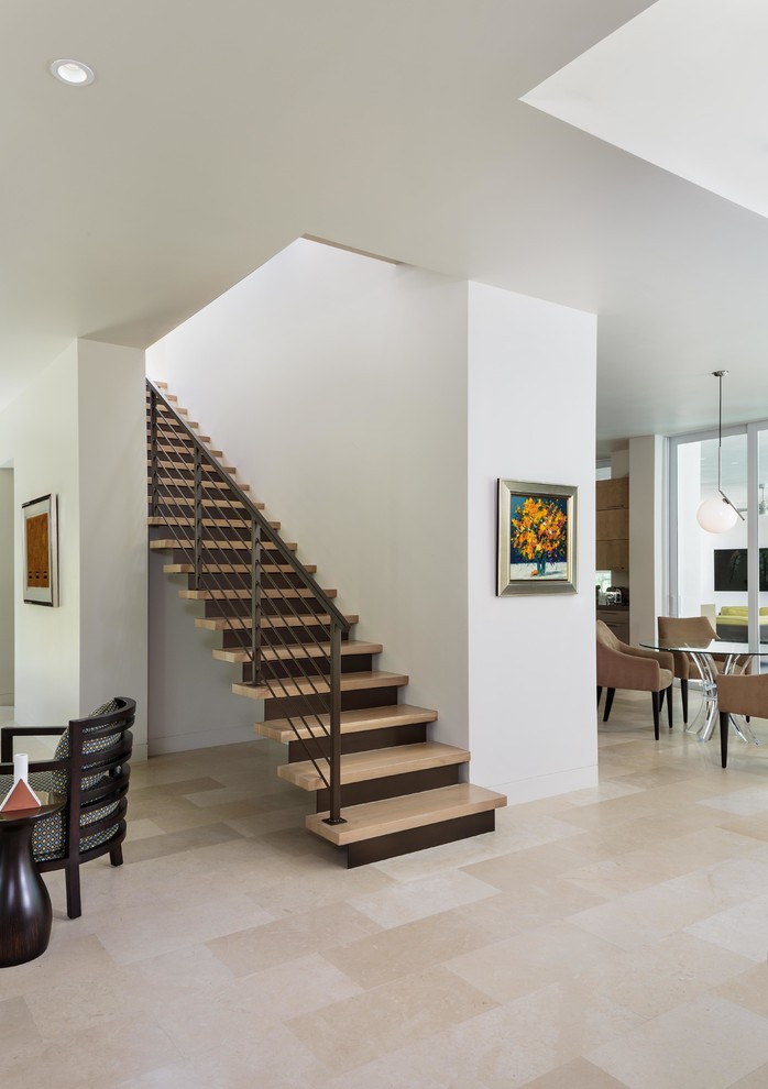 Design ideas for a mid-sized modern wood straight staircase in Miami with metal risers and metal railing.