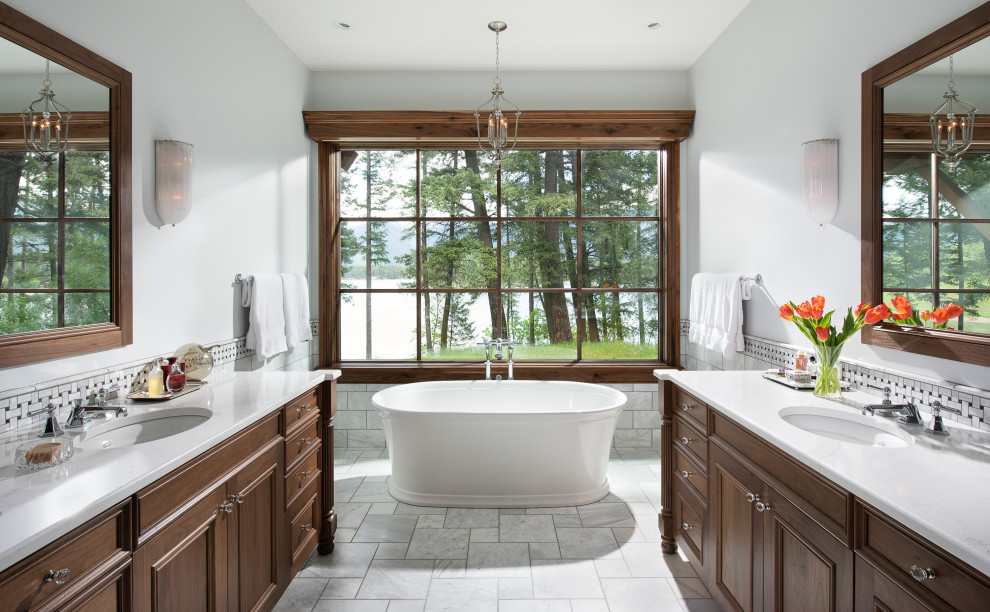 Design ideas for a large traditional master bathroom in Other with dark wood cabinets, a freestanding tub, gray tile, marble, white walls, marble floors, an undermount sink, quartzite benchtops, grey floor, white benchtops, a double vanity, a built-in vanity and recessed-panel cabinets.