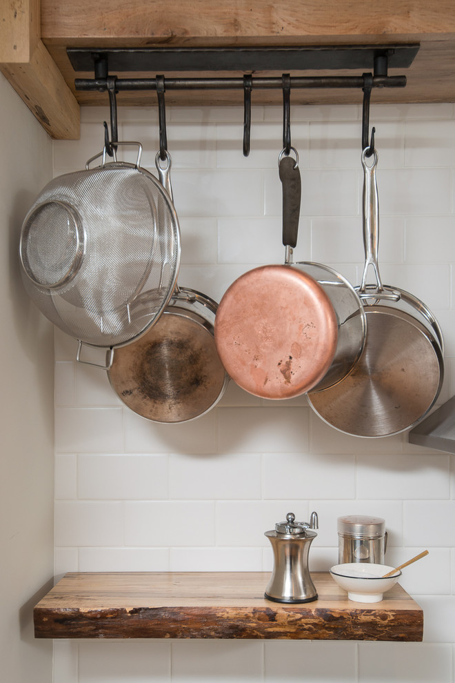 Eat-in kitchen - mid-sized transitional l-shaped eat-in kitchen idea in Boston with recessed-panel cabinets, green cabinets, soapstone countertops, white backsplash, subway tile backsplash, stainless steel appliances and a peninsula
