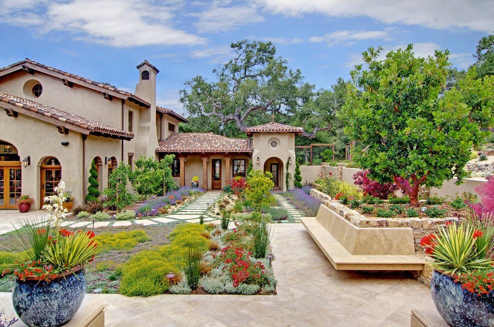 This is an example of a large mediterranean courtyard partial sun formal garden in San Francisco with a water feature and natural stone pavers.