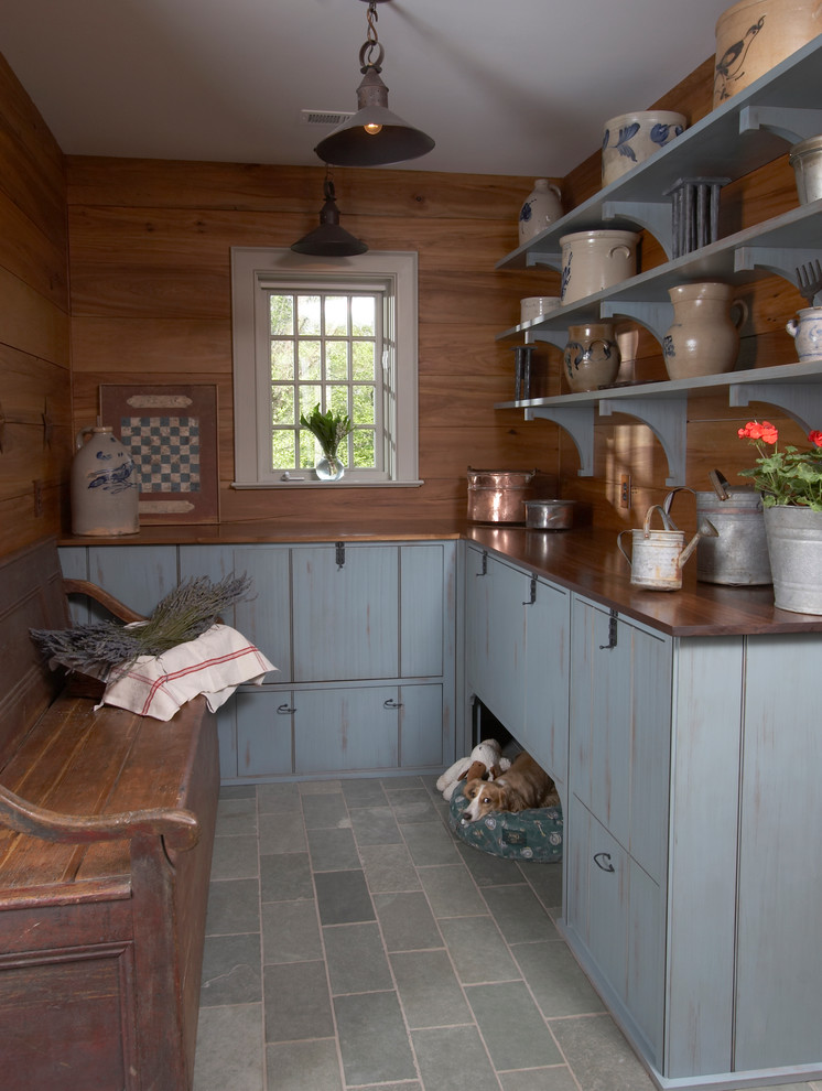 This is an example of a traditional mudroom in New York with grey floor.