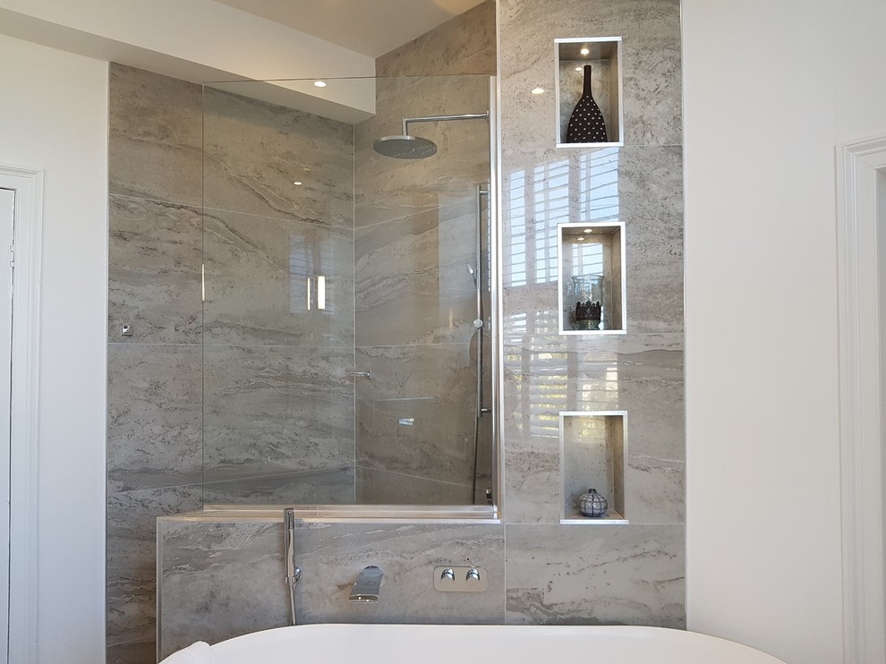 Large contemporary bathroom in Other with flat-panel cabinets, white cabinets, a freestanding bath, a wall mounted toilet, grey tiles, porcelain tiles, grey walls, porcelain flooring, a wall-mounted sink, marble worktops, grey floors, an open shower and white worktops.
