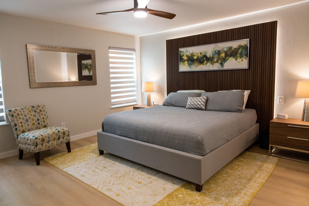Design ideas for a medium sized midcentury master bedroom in Dallas with grey walls, vinyl flooring, no fireplace, beige floors and wood walls.