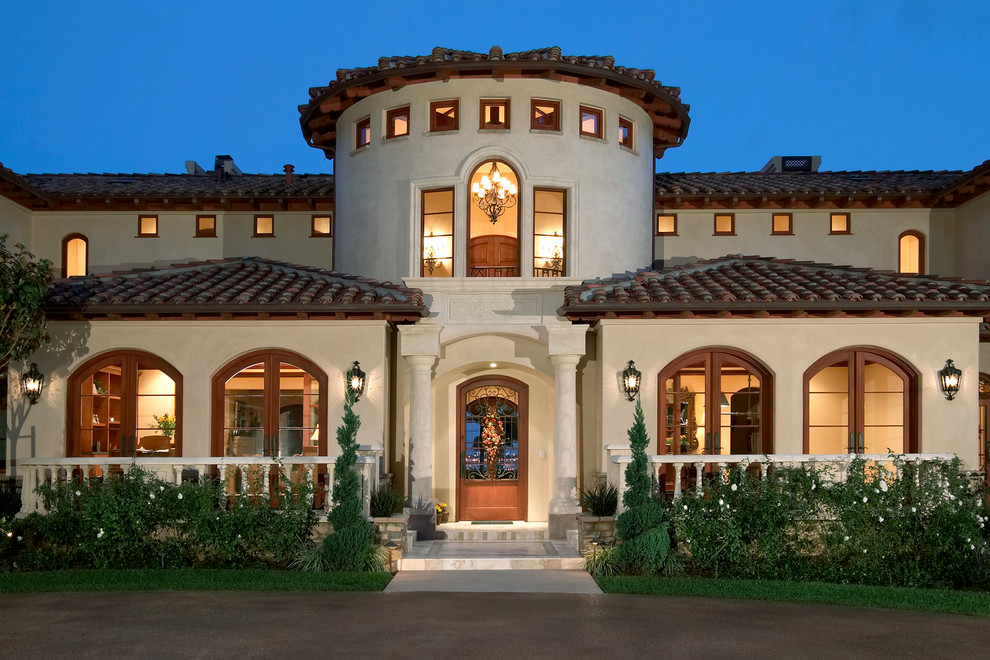 Design ideas for a large mediterranean two-storey stucco beige exterior in San Diego.