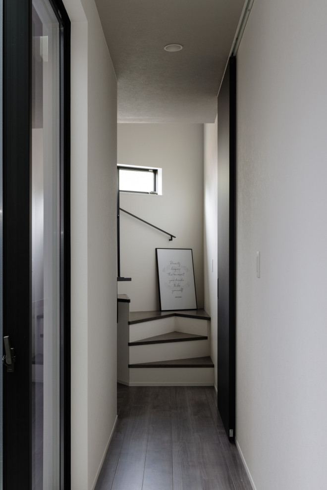 Idée de décoration pour un couloir minimaliste avec un mur blanc, parquet foncé, un sol gris, un plafond en papier peint et du papier peint.