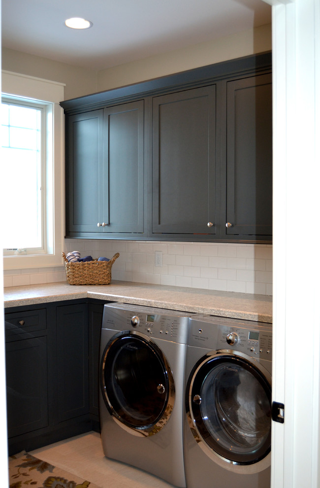 Photo of a large traditional l-shaped dedicated laundry room in Baltimore with a farmhouse sink, recessed-panel cabinets, laminate benchtops and a side-by-side washer and dryer.