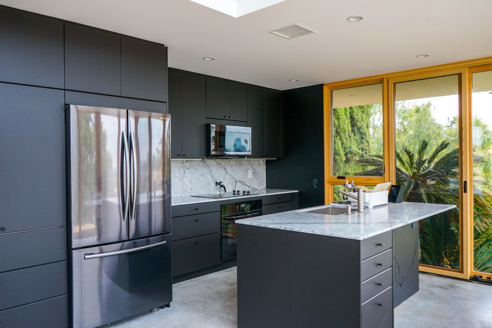 Design ideas for a small modern l-shaped kitchen/diner in Los Angeles with a double-bowl sink, flat-panel cabinets, black cabinets, granite worktops, white splashback, granite splashback, stainless steel appliances, ceramic flooring, an island, white floors and grey worktops.