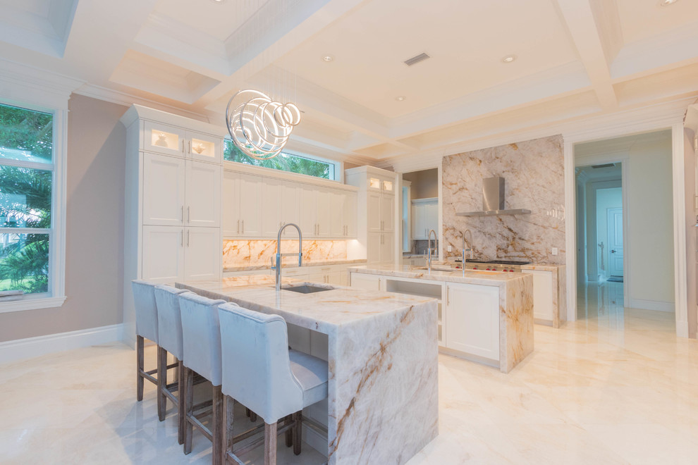 Inspiration for a huge transitional u-shaped marble floor and white floor open concept kitchen remodel with an undermount sink, flat-panel cabinets, white cabinets, quartzite countertops, white backsplash, stone slab backsplash and two islands