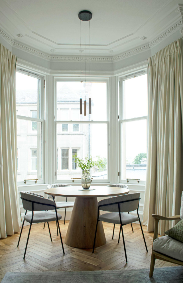 This is an example of a mid-sized scandinavian open plan dining in Edinburgh with grey walls, medium hardwood floors, no fireplace and brown floor.