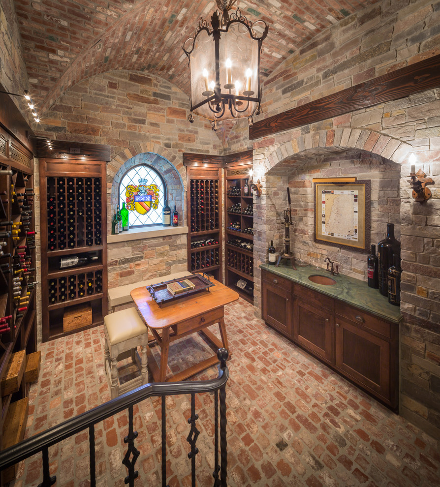 Traditional wine cellar in Houston with brick floors, storage racks and red floor.