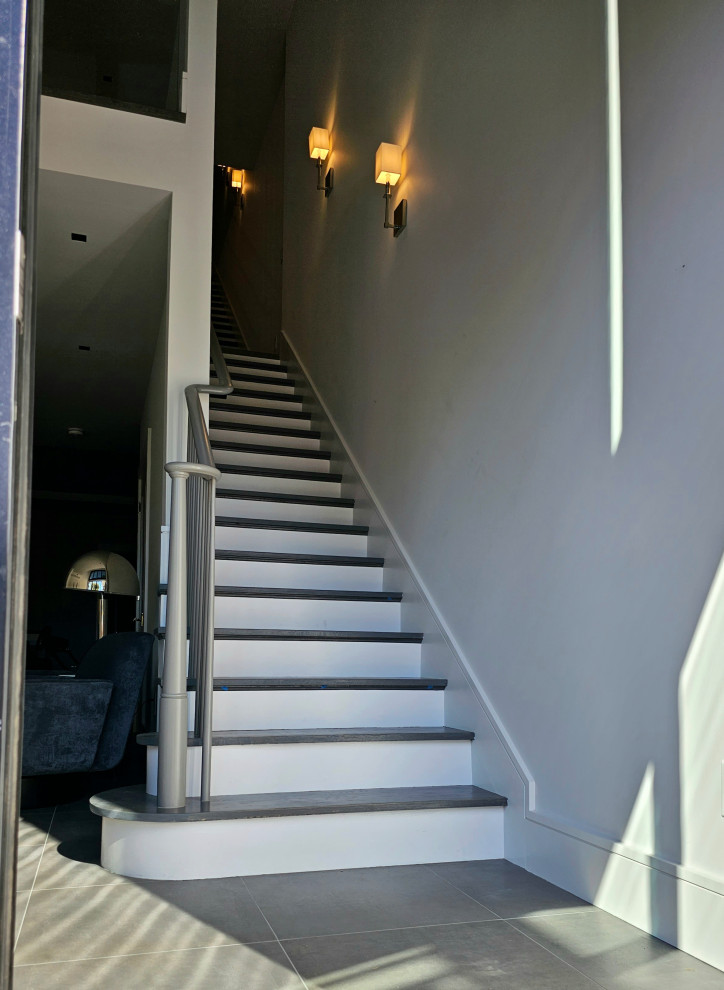 Example of a huge transitional wooden straight wood railing staircase design in DC Metro with painted risers