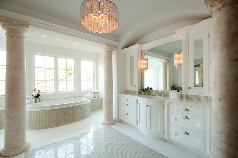 Inspiration for a large traditional master bathroom in Miami with mosaic tile, recessed-panel cabinets, white cabinets, a drop-in tub, white walls, mosaic tile floors, an undermount sink, engineered quartz benchtops and white benchtops.