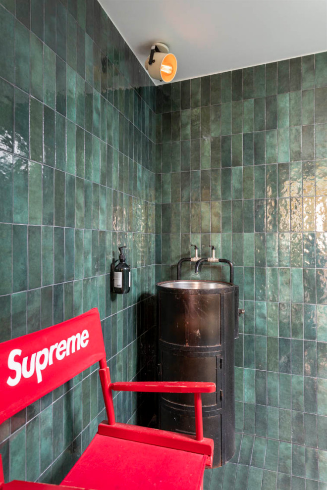 Inspiration for a mid-sized master bathroom in Paris with open cabinets, black cabinets, a curbless shower, a wall-mount toilet, green tile, ceramic tile, green walls, ceramic floors, a pedestal sink, zinc benchtops, turquoise floor, an open shower, black benchtops, a single vanity, a freestanding vanity and decorative wall panelling.