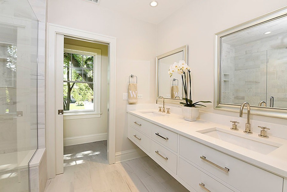 Design ideas for a mid-sized transitional master bathroom in Chicago with flat-panel cabinets, white cabinets, an alcove shower, white tile, marble, grey walls, porcelain floors, an undermount sink, engineered quartz benchtops, white floor, a hinged shower door and white benchtops.