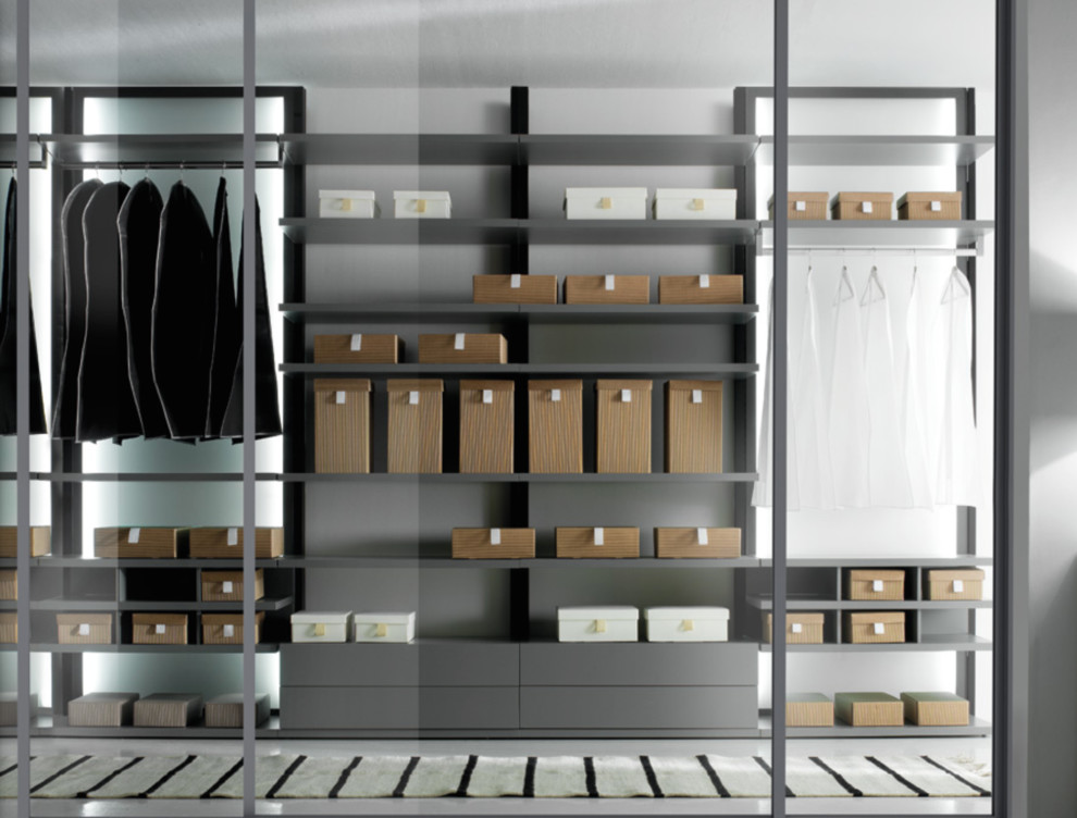 This is an example of a large modern gender-neutral walk-in wardrobe in Los Angeles with flat-panel cabinets, grey cabinets and linoleum floors.