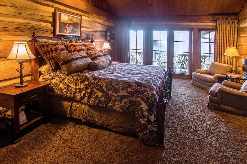 Mid-sized country guest bedroom in Other with brown walls and carpet.