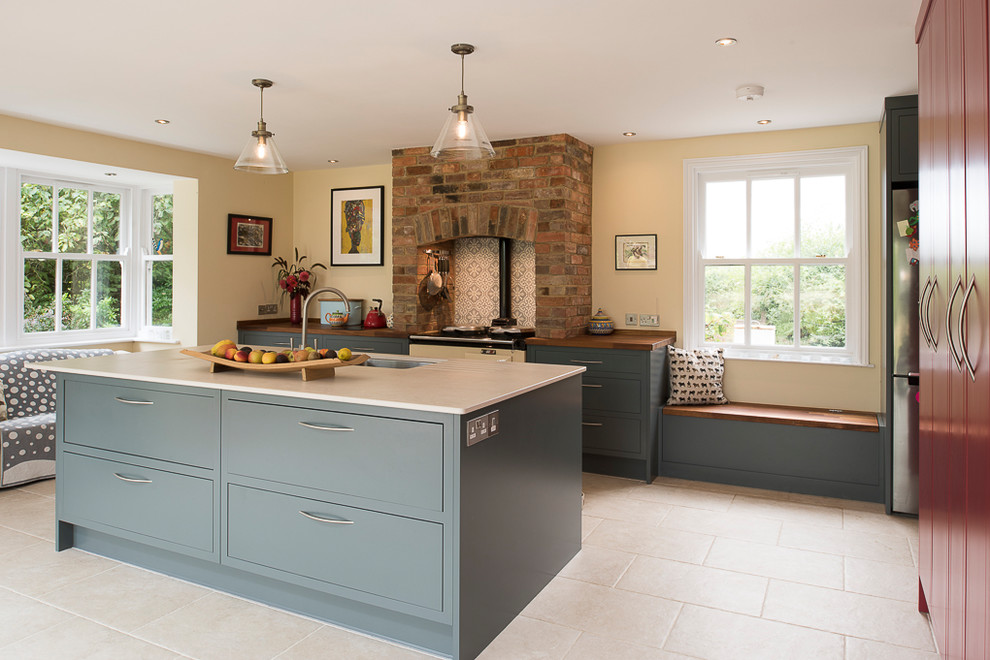 Photo of a mid-sized contemporary l-shaped open plan kitchen in Kent with flat-panel cabinets, grey cabinets, quartzite benchtops, porcelain floors, with island, beige floor, brown benchtop, an undermount sink and ceramic splashback.