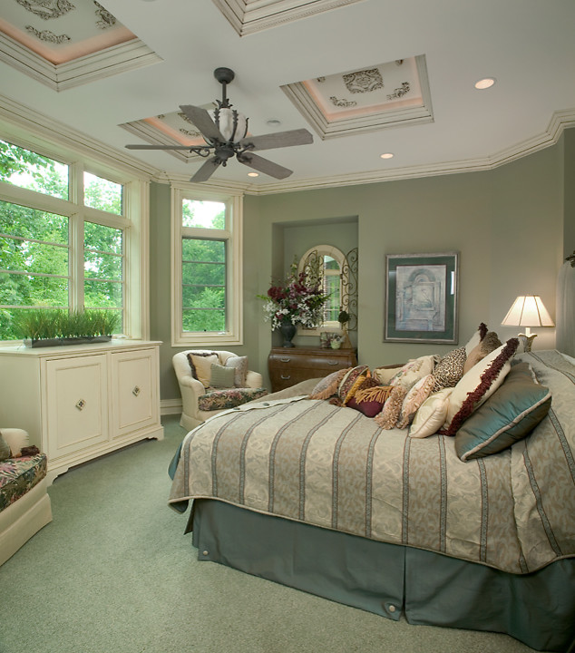 Expansive traditional master bedroom in Grand Rapids with green walls and carpet.