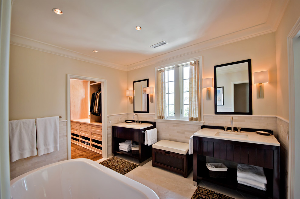 Inspiration for an expansive transitional master bathroom in Nashville with an undermount sink, furniture-like cabinets, dark wood cabinets, granite benchtops, a freestanding tub, white tile, matchstick tile, white walls and terra-cotta floors.