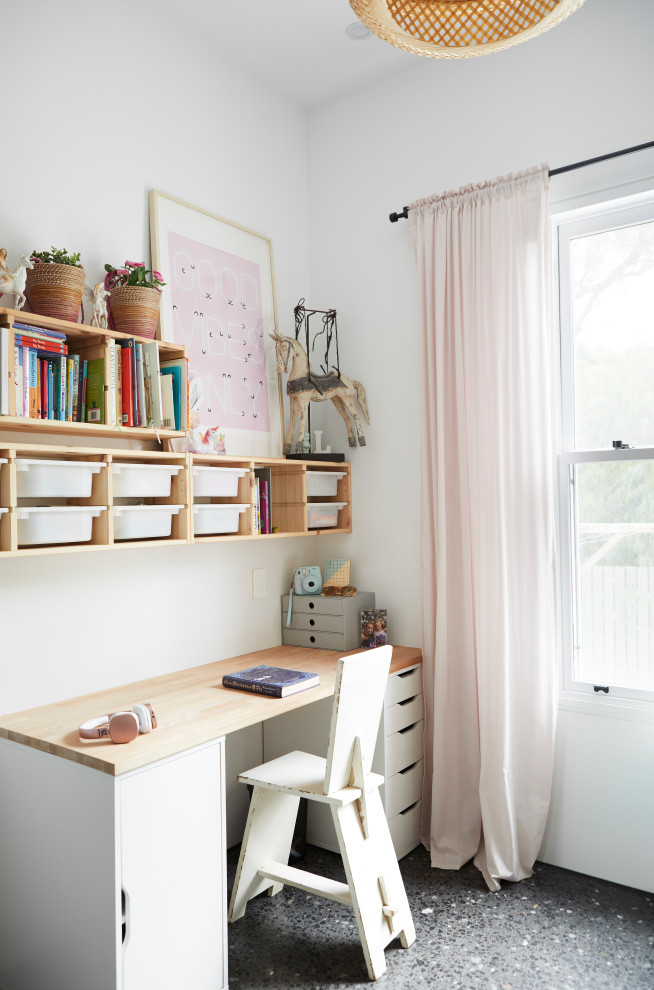 Photo of a mid-sized scandinavian kids' bedroom for kids 4-10 years old and girls in Other with white walls, concrete floors and grey floor.