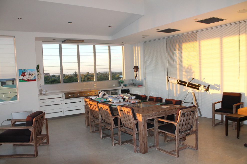 Photo of a large contemporary kitchen/dining combo in Perth with white walls, ceramic floors, no fireplace and grey floor.