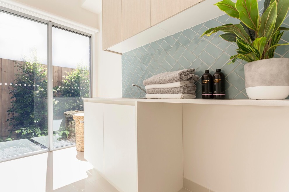 This is an example of a beach style laundry room in Melbourne.