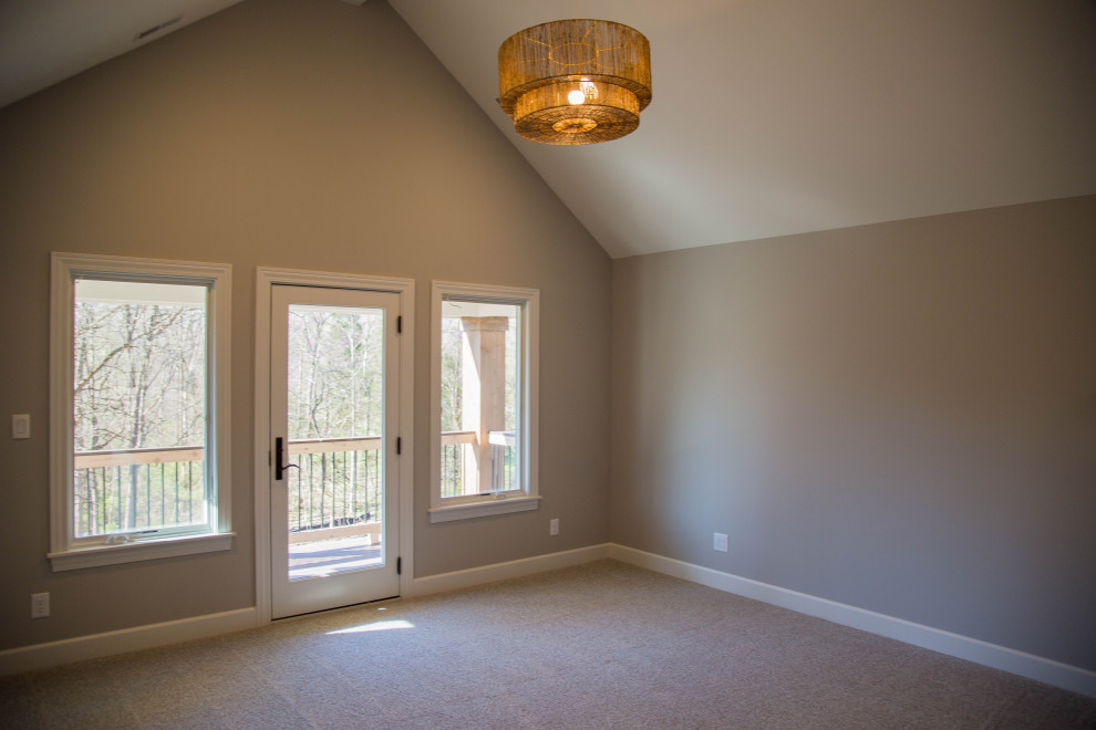 Photo of a large transitional master bedroom in Indianapolis with beige walls, carpet, beige floor and vaulted.