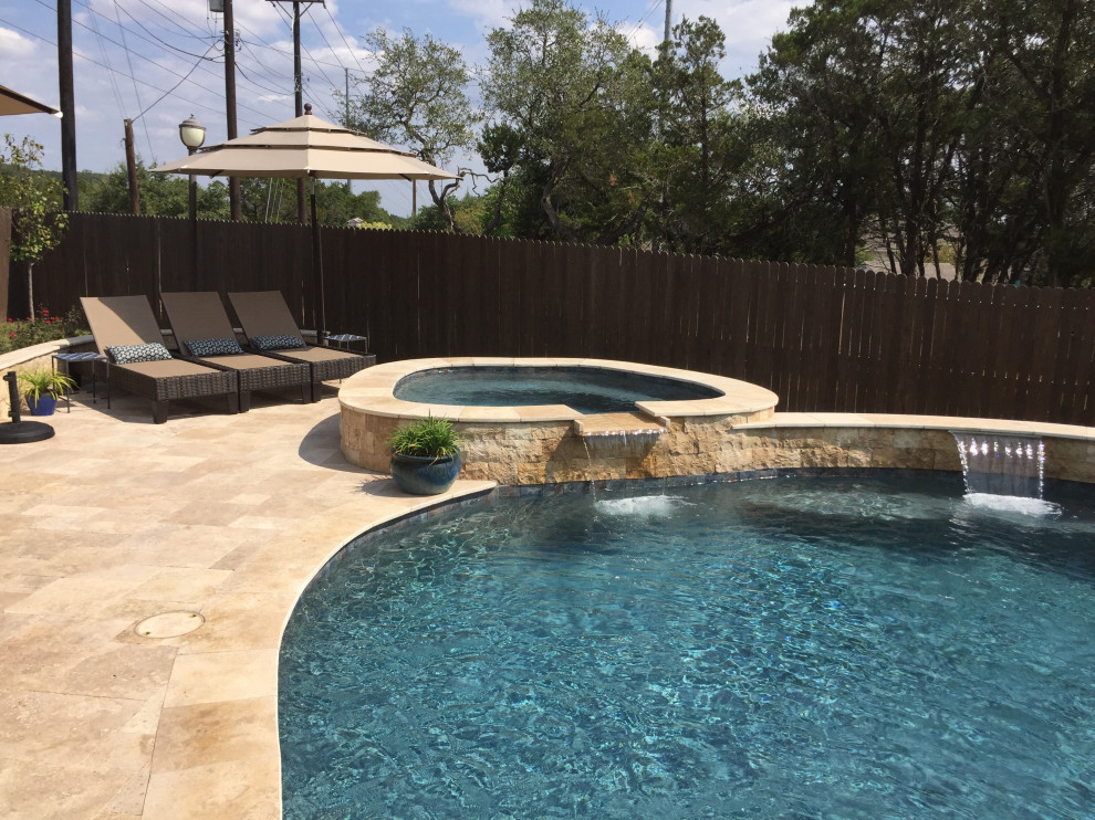 Large traditional backyard custom-shaped aboveground pool in Austin with a water feature and decking.