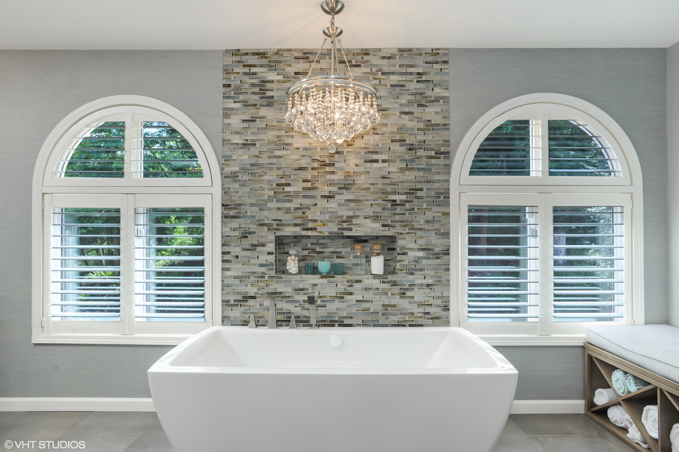 Mid-sized transitional master multicolored tile and mosaic tile ceramic tile freestanding bathtub photo in Seattle with an undermount sink, shaker cabinets, medium tone wood cabinets, marble countertops, a bidet and gray walls