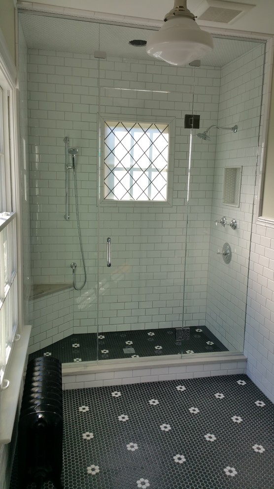 Photo of a large traditional master bathroom in Chicago with raised-panel cabinets, brown cabinets, an open shower, a two-piece toilet, white tile, subway tile, beige walls, mosaic tile floors, an undermount sink, marble benchtops, black floor and a hinged shower door.